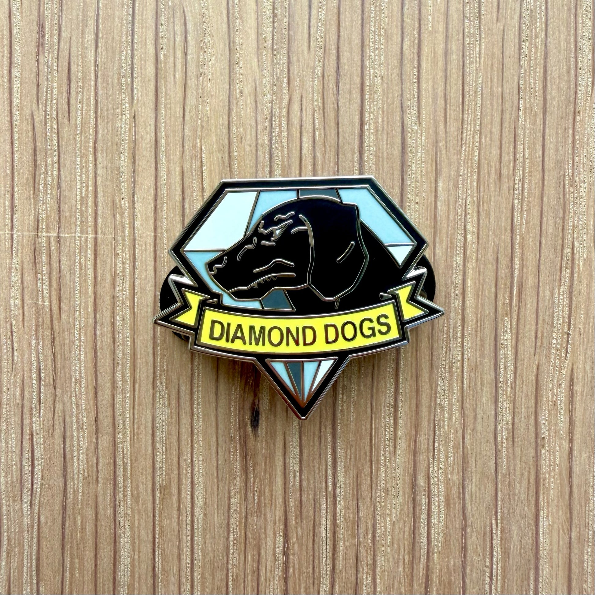 Metal Gear style military unit wolf pin on wooden background