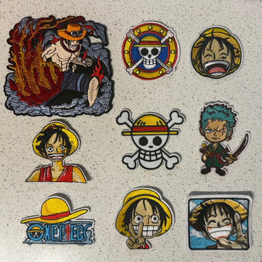 Nine One Piece embroidered patches featuring Luffy, Zoro, Ace and colourful Straw Hat Pirates logo designs.